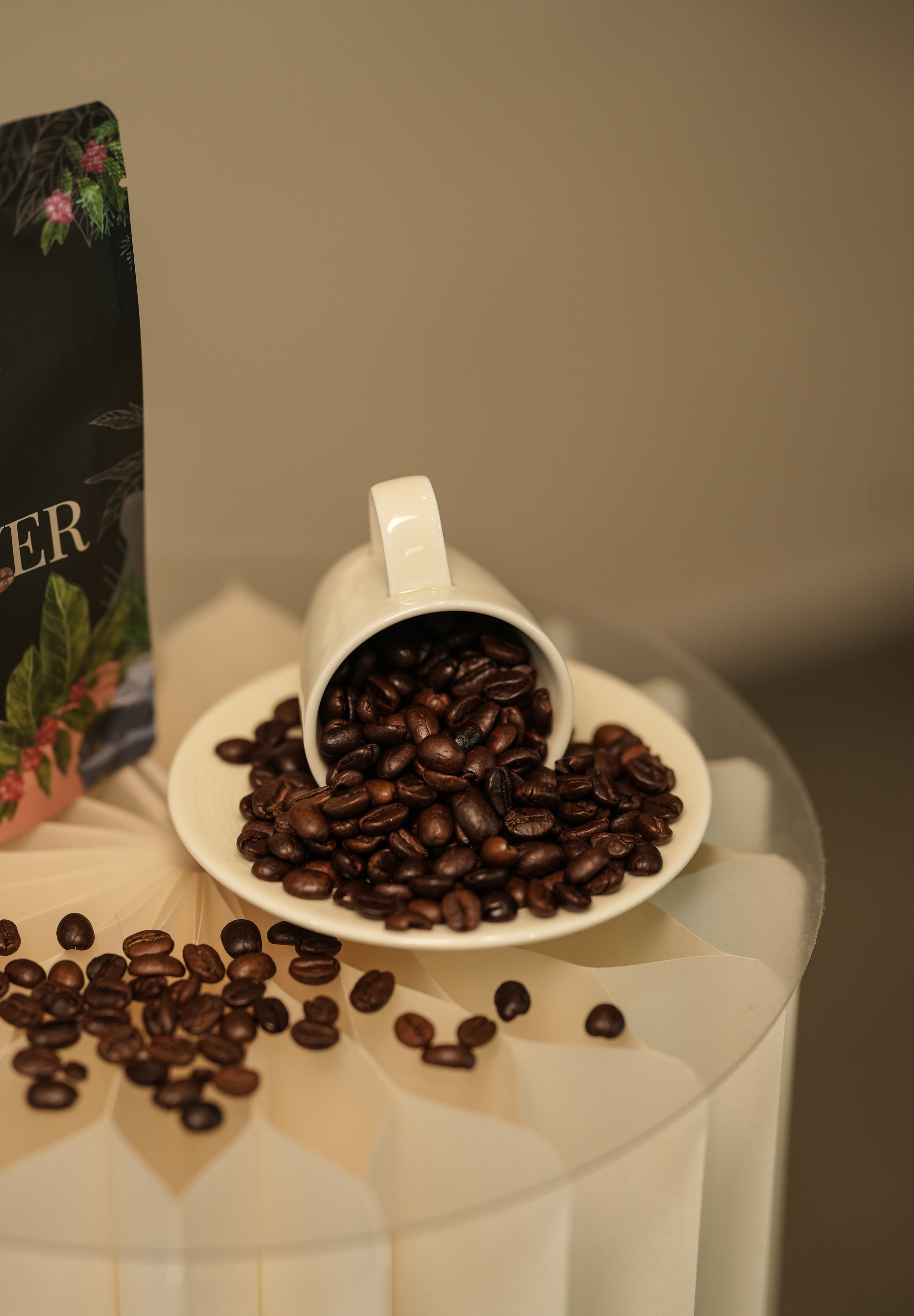 Detail of coffee beans spilling from a cup