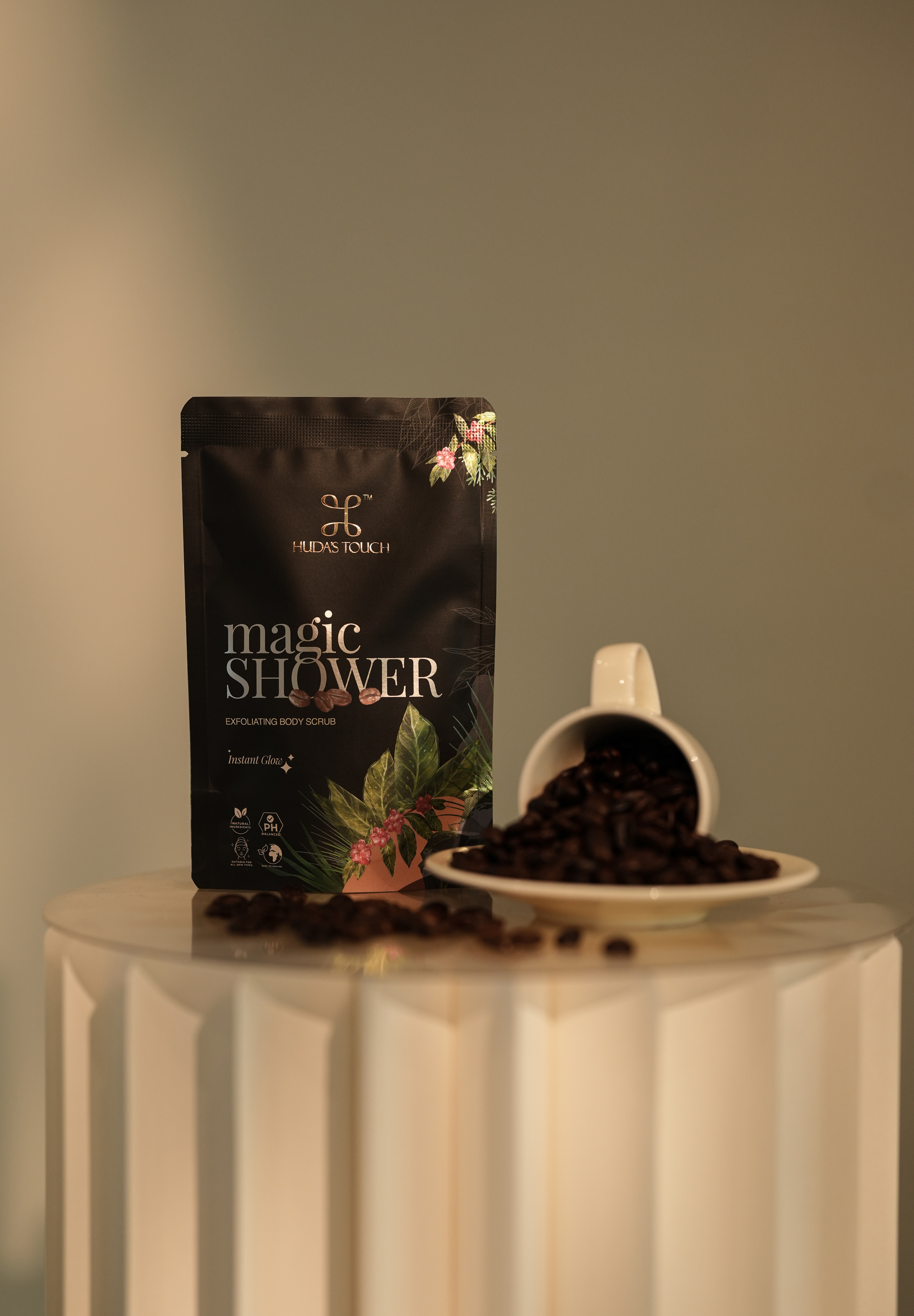 Magic Shower sachet beside a cup of coffee beans