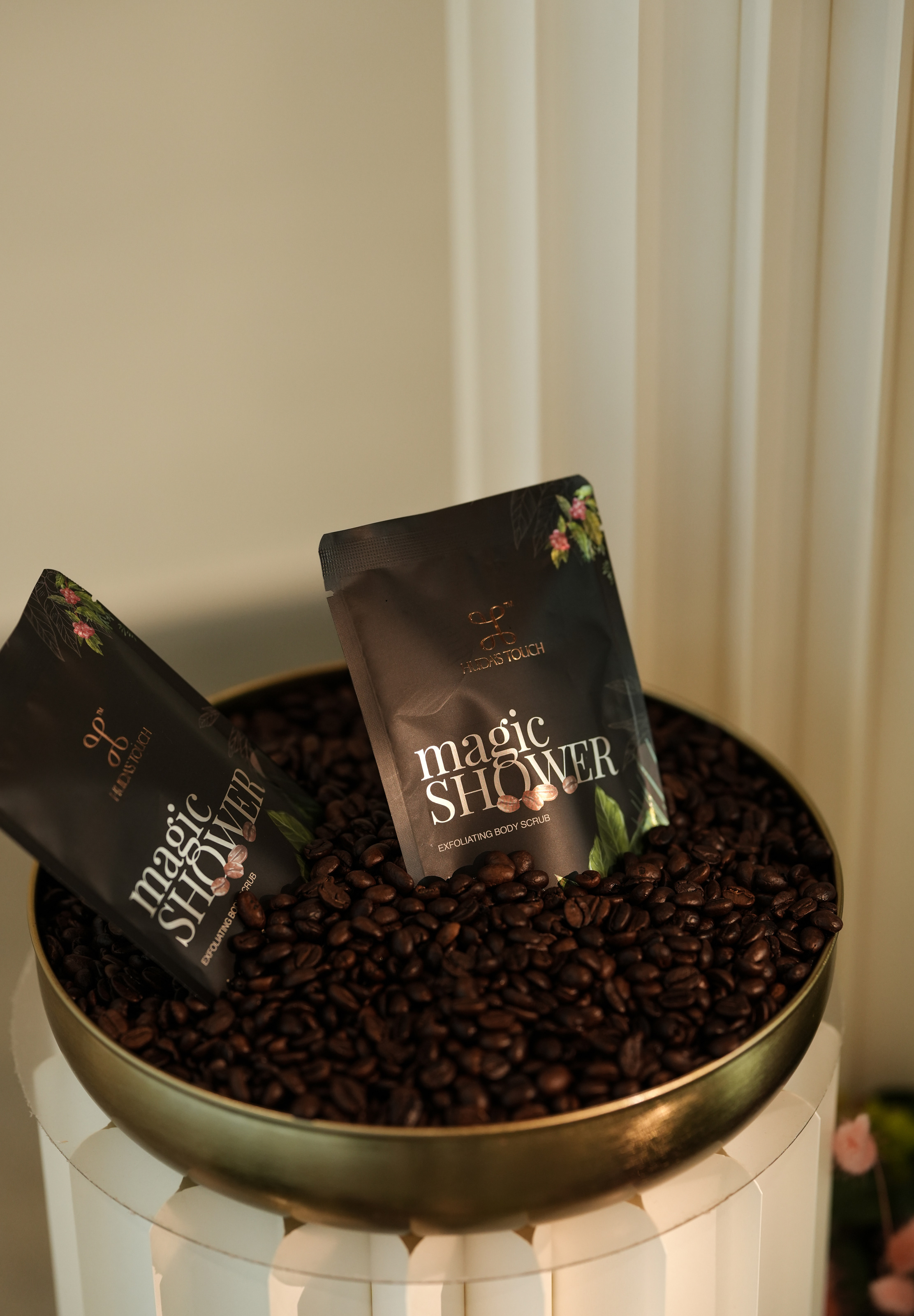 Two sachets in a brass bowl of coffee beans